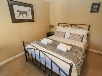 a bedroom with a bed with two pillows at Clerk Beck Cottage in Ulverston