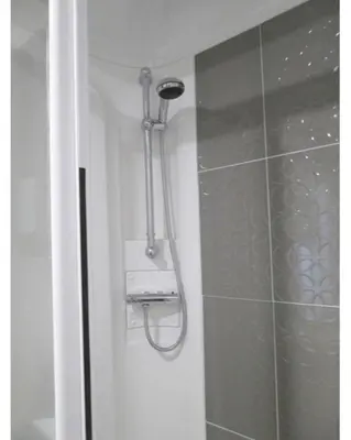 a shower with a shower head in a bathroom at 37 Bay View Oceans Edge by Waterside Holiday Lodges in Lancaster