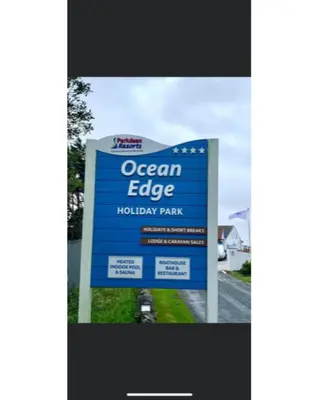 a sign for an ocean edge holiday park at 37 Bay View Oceans Edge by Waterside Holiday Lodges in Lancaster