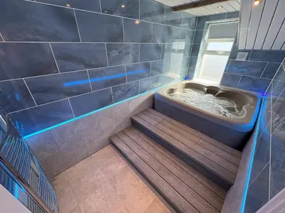 a bathroom with a shower with a toilet in it at Edward Place Luxury Hot Tub Apartments in Blackpool