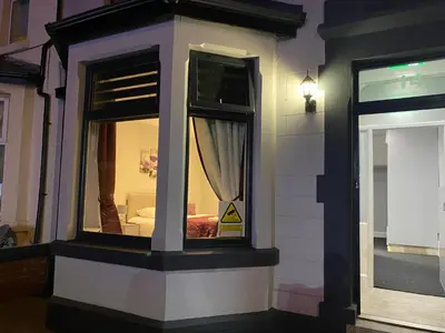 a building with a window with a bed in it at Edward Place Luxury Hot Tub Apartments in Blackpool