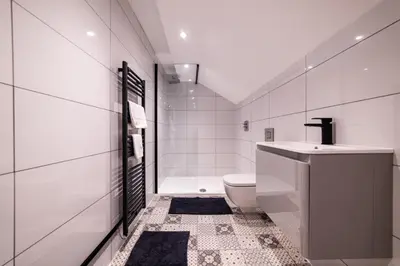 a white bathroom with a toilet and a sink at Hollywood Suite Sasco Apartments in Blackpool