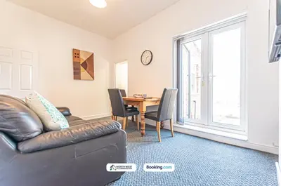 a living room with a leather couch and a table at Modern 3BR House in Ince Ideal for Contractors & Long Stays in Pemberton