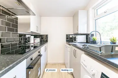 a kitchen with white cabinets and a sink at Modern 3BR House in Ince Ideal for Contractors & Long Stays in Pemberton
