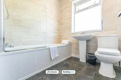 a bathroom with a toilet and a tub and a sink at Modern 3BR House in Ince Ideal for Contractors & Long Stays in Pemberton