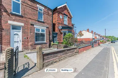 a brick building with a white door on a street at Modern 3BR House in Ince Ideal for Contractors & Long Stays in Pemberton