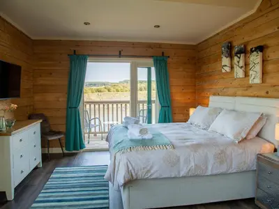 a bedroom with a bed and a balcony at Casa Loma in Carnforth