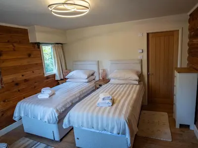 two beds sitting next to each other in a bedroom at Casa Loma in Carnforth