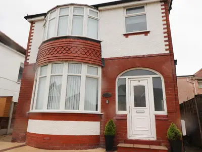 a red brick house with a white door at 23 Ryden Avenue in Cleveleys