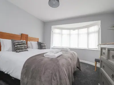 a bedroom with a bed and a window at 23 Ryden Avenue in Cleveleys