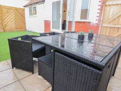 a patio with a black table and chairs at 23 Ryden Avenue in Cleveleys