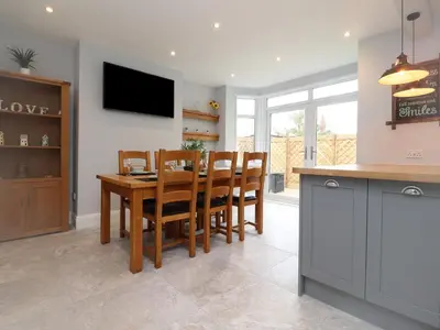a kitchen and dining room with a table and chairs at 23 Ryden Avenue in Cleveleys