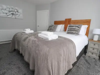 a bedroom with a large bed with towels on it at 23 Ryden Avenue in Cleveleys