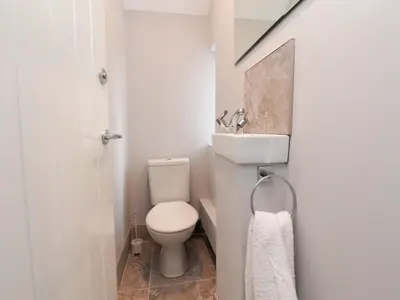 a small bathroom with a toilet and a sink at 23 Ryden Avenue in Cleveleys