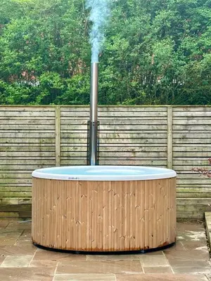 a hot tub with smoke coming out of it at Elletson Park Wood fired Hot tubs, Caravans & Pods in Preston