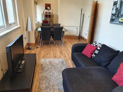 a living room with a couch and a table with chairs at Marina Court LA14 2HL in Barrow in Furness