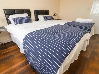 two beds sitting next to each other in a bedroom at The Beach House in Cleveleys