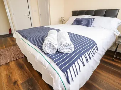 a blue and white bed with two pillows on it at The Beach House in Cleveleys