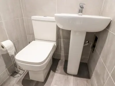 a bathroom with a white toilet and a sink at The Beach House in Cleveleys