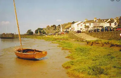 a boat sitting in the water in a river at Milo’s Retreat in Arnside
