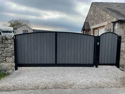 a black gate in front of a house at Milo’s Retreat in Arnside
