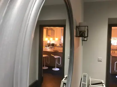 an archway leading into a kitchen with a mirror at North Lodge in Lancaster