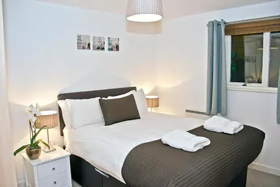 a bedroom with a bed with two towels on it at Base Serviced Apartments - Duke Street in Liverpool