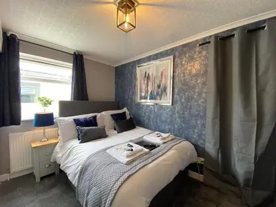 a bedroom with a bed with two towels on it at Delovely Hotel in Blackpool