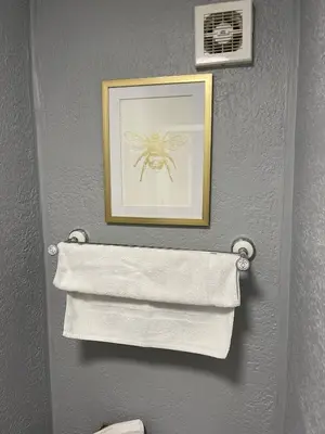 a picture of a spider on a wall with towels at Delovely Hotel in Blackpool
