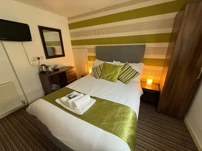 a hotel room with a bed with towels on it at Delovely Hotel in Blackpool
