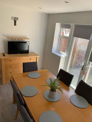 a dining room table with a potted plant on it at Beautiful house in a perfect location in Saint Annes on the Sea