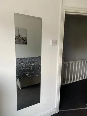 a mirror in front of a bedroom with a bed at Beautiful house in a perfect location in Saint Annes on the Sea