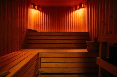 an empty sauna with red lights on the wall at Laythams Holiday Lets Retreat in Slaidburn