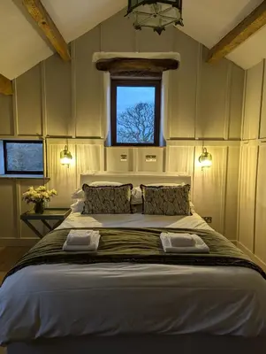 a bedroom with a large bed with a window at Laythams Holiday Lets Retreat in Slaidburn