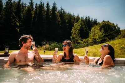 a group of people drinking wine in a hot tub at Laythams Holiday Lets Retreat in Slaidburn
