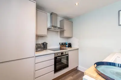 a kitchen with a sink and a bath tub at Host & Stay - The Pilgrim Coach Houses in Liverpool