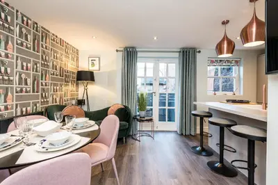 a living room with a table and chairs at Host & Stay - The Pilgrim Coach Houses in Liverpool