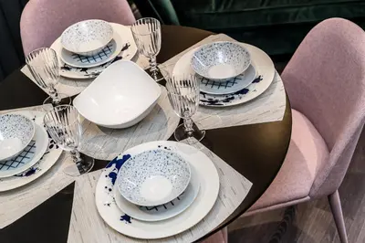 a wooden table with plates and wine glasses on it at Host & Stay - The Pilgrim Coach Houses in Liverpool