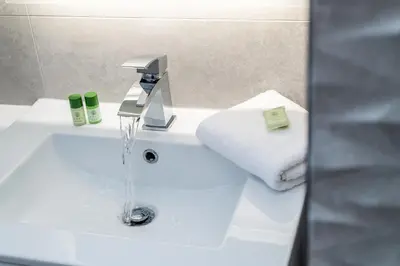 a bathroom sink with water running from a faucet at Host & Stay - The Pilgrim Coach Houses in Liverpool