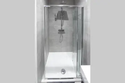 a shower with a glass door in a bathroom at BlackBird Luxury Accommodation Room 6 in Blackpool