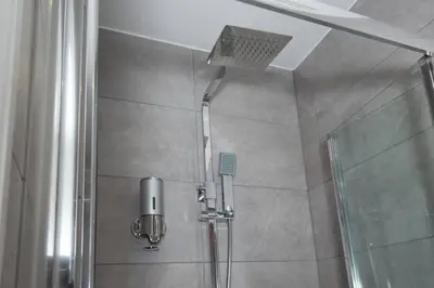 a shower with a shower head in a bathroom at BlackBird Luxury Accommodation Room 6 in Blackpool