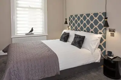 a bedroom with a large bed and a window at BlackBird Luxury Accommodation Room 6 in Blackpool