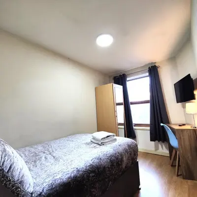 a bedroom with a bed and a window at Liverpool City Centre Private Rooms including smart TVs - with Shared Bathroom in Liverpool