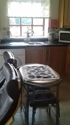 a kitchen with a table and a sink and a table at Harris End in Lancaster