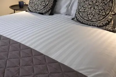 a white bed with two pillows on top of it at Blackbird Luxury 2 Bed Accommodation Room 7 in Blackpool