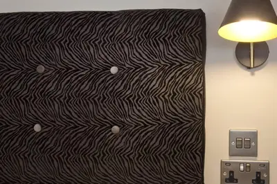 a black and white bed with a lamp next to it at Blackbird Luxury 2 Bed Accommodation Room 7 in Blackpool