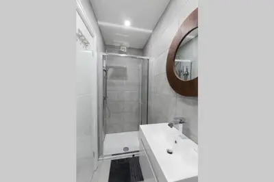 a bathroom with a shower and a sink and a mirror at Blackbird Luxury 2 Bed Accommodation Room 7 in Blackpool