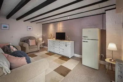 a living room with a couch and a refrigerator at Cottage - Sleeps4 - PetFriendly - Garden - ByBeach in Saint Annes on the Sea