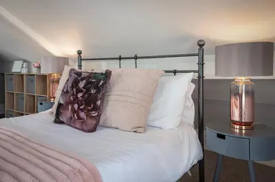 a bedroom with a bed with a pillow and a lamp at Cottage - Sleeps4 - PetFriendly - Garden - ByBeach in Saint Annes on the Sea