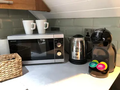 a microwave on a counter with two cups on top at Cottage - Sleeps4 - PetFriendly - Garden - ByBeach in Saint Annes on the Sea